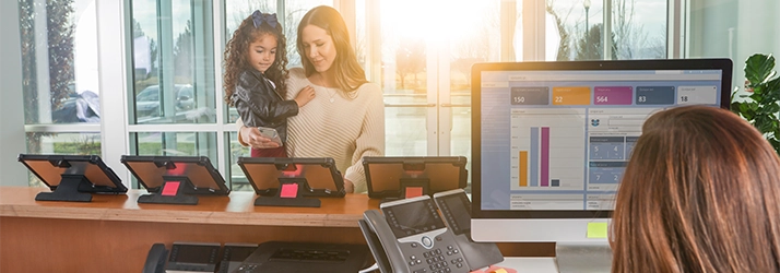 Chiropractic La Crosse WI Woman With Child At A Reception Desk